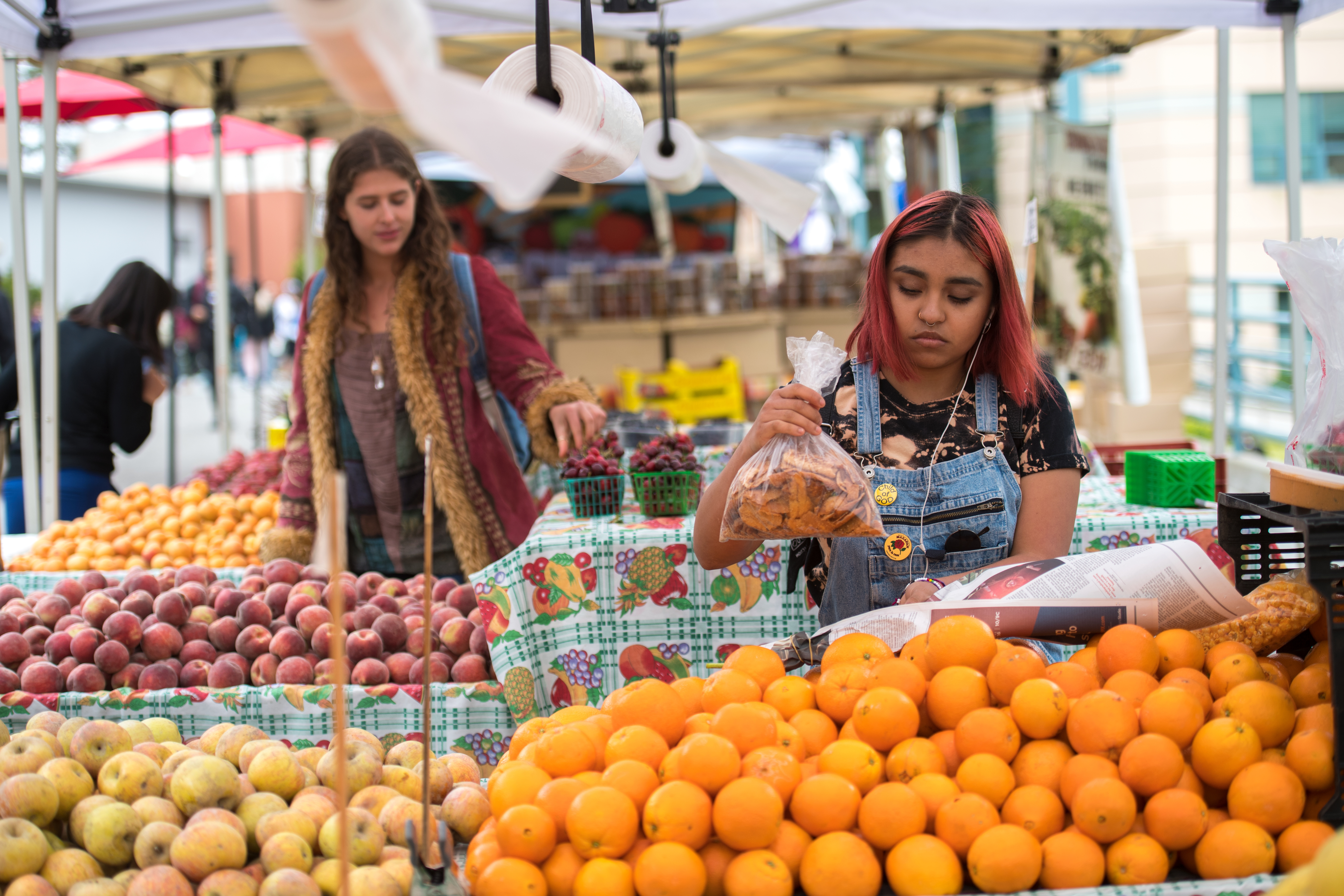 Student picking fruit from farmer's market