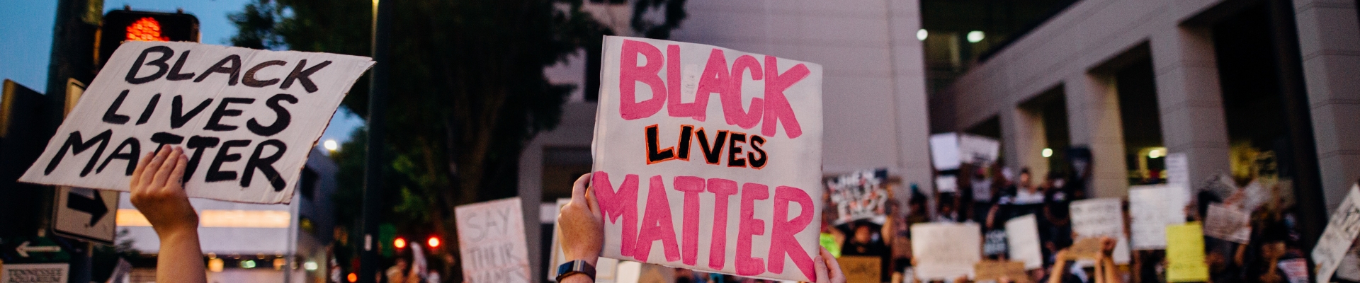 Marchers hold up Black Lives Matter signs at Administration building